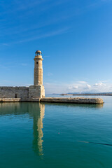 The iconic lighthouse of the old Venetian harbor of Rethymno (also Rethimno, Rethymnon, and Rhithymnos) on the north coast of Crete, Greece.