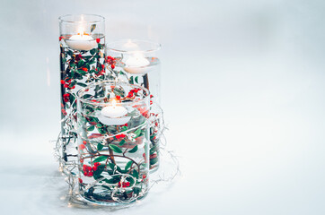 creative ideas with candle, plants and vase full of water, christmas concept