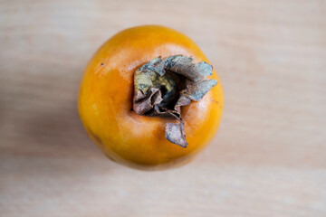 Persimmon fruit on  a wooden bakground, close up, macro photography, above vantage point photography