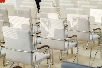 White plastic chairs in presentation room. Business meeting room. Sunny day