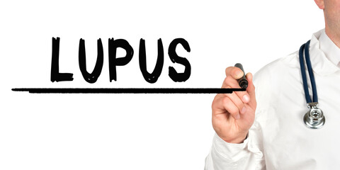 Doctor writes the word - LUPUS. Image of a hand holding a marker isolated on a white background.