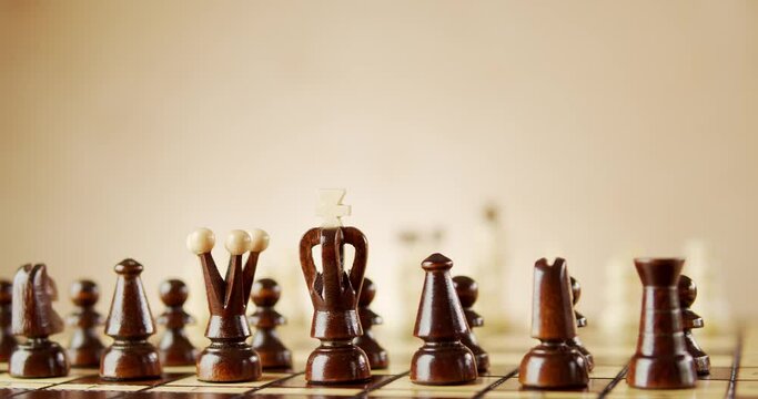rotating old wooden chess pieces on a chessboard