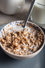 Oat rye flakes in bowl with milk. 