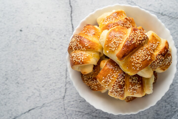 Close up on homemade cheese croissants in ceramic bowl on the marble table - homemade snack for breakfast - organic healthy traditional serbian food top view copy space