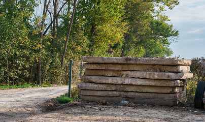 Several old reinforced concrete slabs are stored outside.Landfill concrete slabs