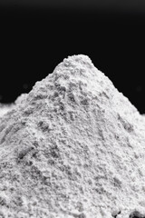 Small pile of flour, close-up. Starch-dehydrated powder, obtained from ground cereals, cassava or other vegetables.