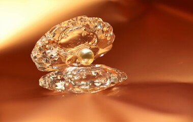 A pearl inside shell shiny crystal show piece isolated on beautiful golden background and the reflection also seen  