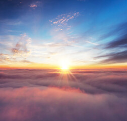Rising sunset above the clouds
