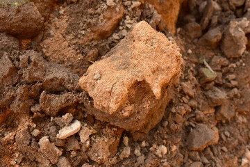 Sand background with pieces of clay and earth