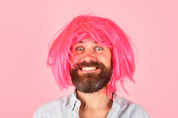 Smiling man in wig. Happy man in color wig. Smile. Close up portrait of smiling bearded man....
