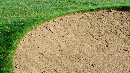 Golf bunker showing grass and sand with space for copy
