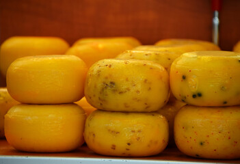 Small heads of hard cheese on retail display