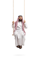 Saudi arab man in a thobe sitting on a swing