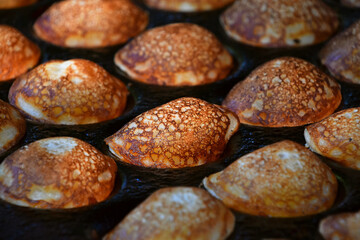 Close up cooking small Dutch traditional pancakes