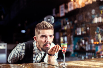 Young tapster demonstrates his professional skills in the bar