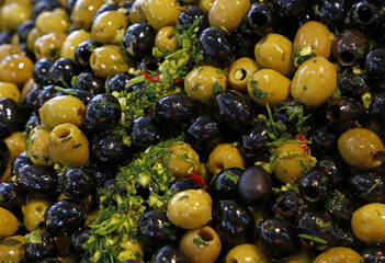 Pickled black and green olives on retail display