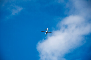 Flying airplane on the blue sky and cloud at sunrise