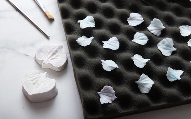 Create textured polymer clay hydrangea petals using a weiner and drying on paralon