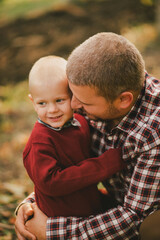 Fototapeta premium Happy father and son taking a walk in vineyard at sunset.