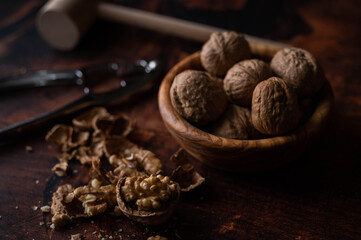 walnut with nutscracke on dark wooden backgrround