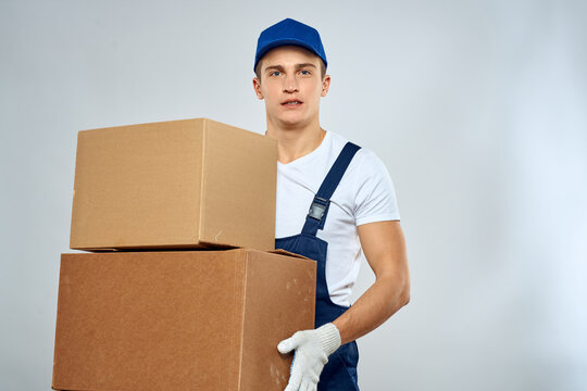 working man in uniform with boxes in his hands delivery loader lifestyle
