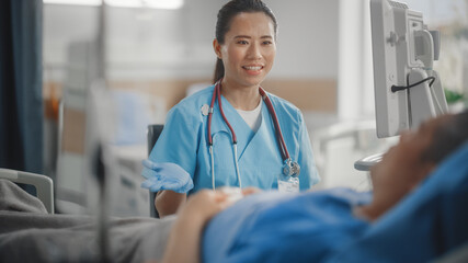 Hospital Ward: Portrait of Professional Chinese Head Nurse Doing Patient Vital's Checkup,...