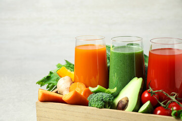 Delicious vegetable juices and fresh ingredients on light background, closeup