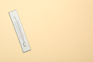 Weather thermometer on beige background, top view. Space for text