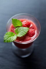 Fresh smoothie in a glass. Dark background. Close up. 