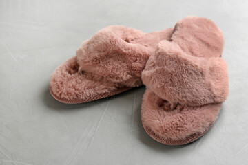 Fototapeta na wymiar Pair of soft slippers on light grey background