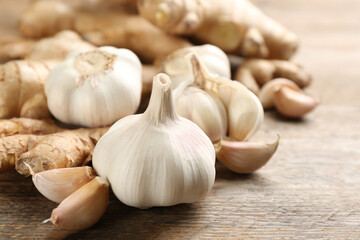 Ginger and fresh garlic on wooden table, closeup. Natural cold remedies