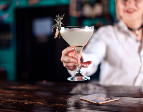 Girl barman creates a cocktail in the porterhouse