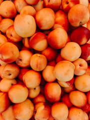lots of ripe fruit sweet peaches for cooking as a background