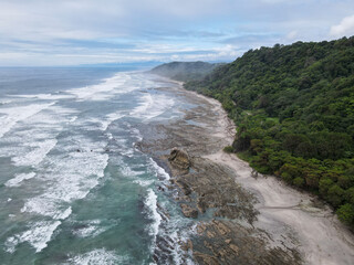 	
Lush Tropical Beach Paradise with blue water, great waves and rock formations in Malpais / Santa Teresa, Nicoya Peninsula Costa Rica	
