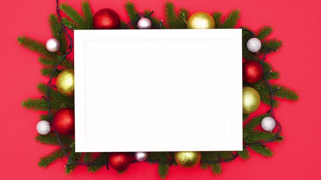 Blinking lights on Christmas frame with pine branches and Christmas ornaments. Stop motion