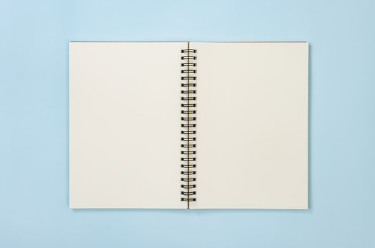Top Table Spiral Notebook or Spring Notebook Mock up in Unlined Type on Center Frame on Blue Pastel Minimalist Background