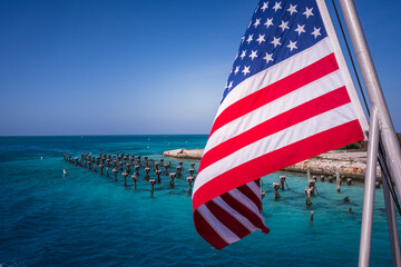 American Flag Waves Over Ruins