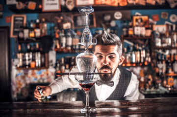 Bartender mixes a cocktail on the alehouse