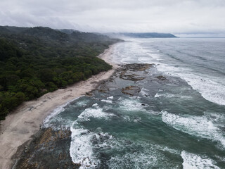 	
Lush Tropical Beach Paradise with blue water, great waves and rock formations in Malpais / Santa Teresa, Nicoya Peninsula Costa Rica	
