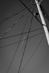 Contrail of Plane Contrasted with Black Telephone Wires. Fusion of Communication and Ideas Concept.