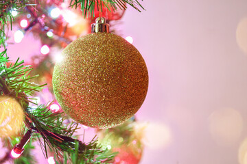Close up to Christmas sphere in gold color with glitter.