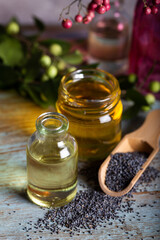 Poppy seeds with essential oil in a small jar.