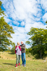 Fototapeta premium Senior couple on a walk in an autumn nature.