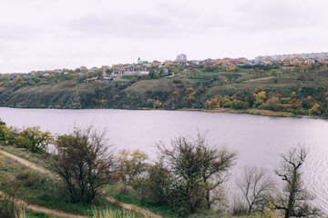 Fototapeta na wymiar Autumn forest river scene. Forest river in autumn fall. Autumn fall forest river landscape. Dnipro. Ukraine. Island Khortysia