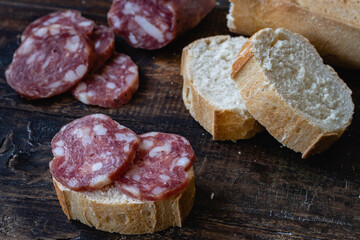 salame de la colonia tipo casero sin cascara con especies pimienta pan sobre madera  cordoba argentina