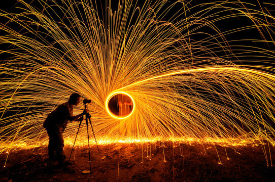 Side View Of Man Photographing Wire Wool At Night