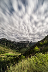 Clouds over pyrenees mountains long exposured