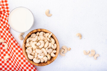Vegan Cashew nut milk on white background. Non dairy alternative vegan milk. Healthy vegetarian food and drink. Copy space, top view