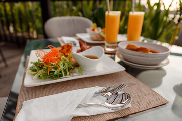 Dinner in outdoor reataurant served for two - grilled fish, prawns, potatoes, green salad and...