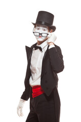 Portrait of male mime artist performing, isolated on white background. Mime lowered his glasses to look directly into eyes